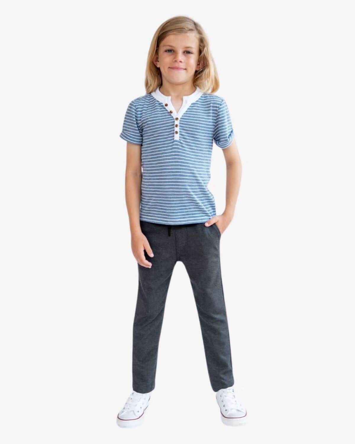 Child wearing Dark Grey Everyday Stretch Pants with a striped blue shirt, showcasing comfort and style for kids.