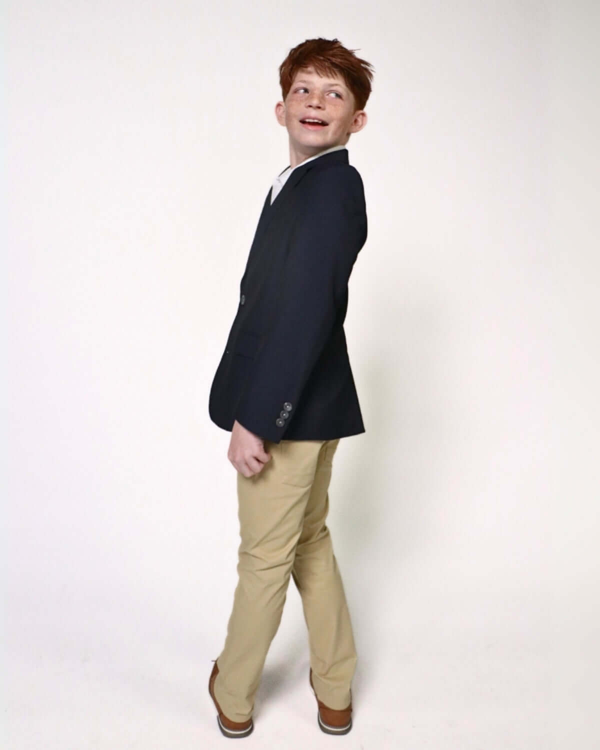 Child modeling an Indigo Suit Blazer with khaki pants, showcasing a stylish and polished look.