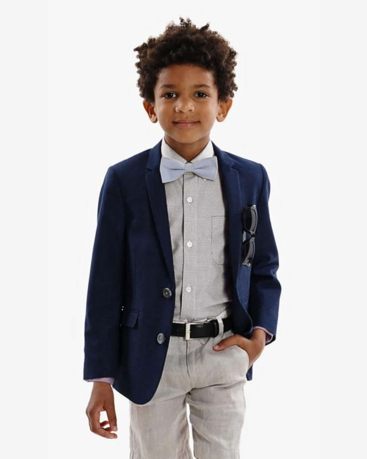 Boy wearing an Indigo Suit Blazer, paired with a button-down shirt and bow tie, showcasing a polished look.