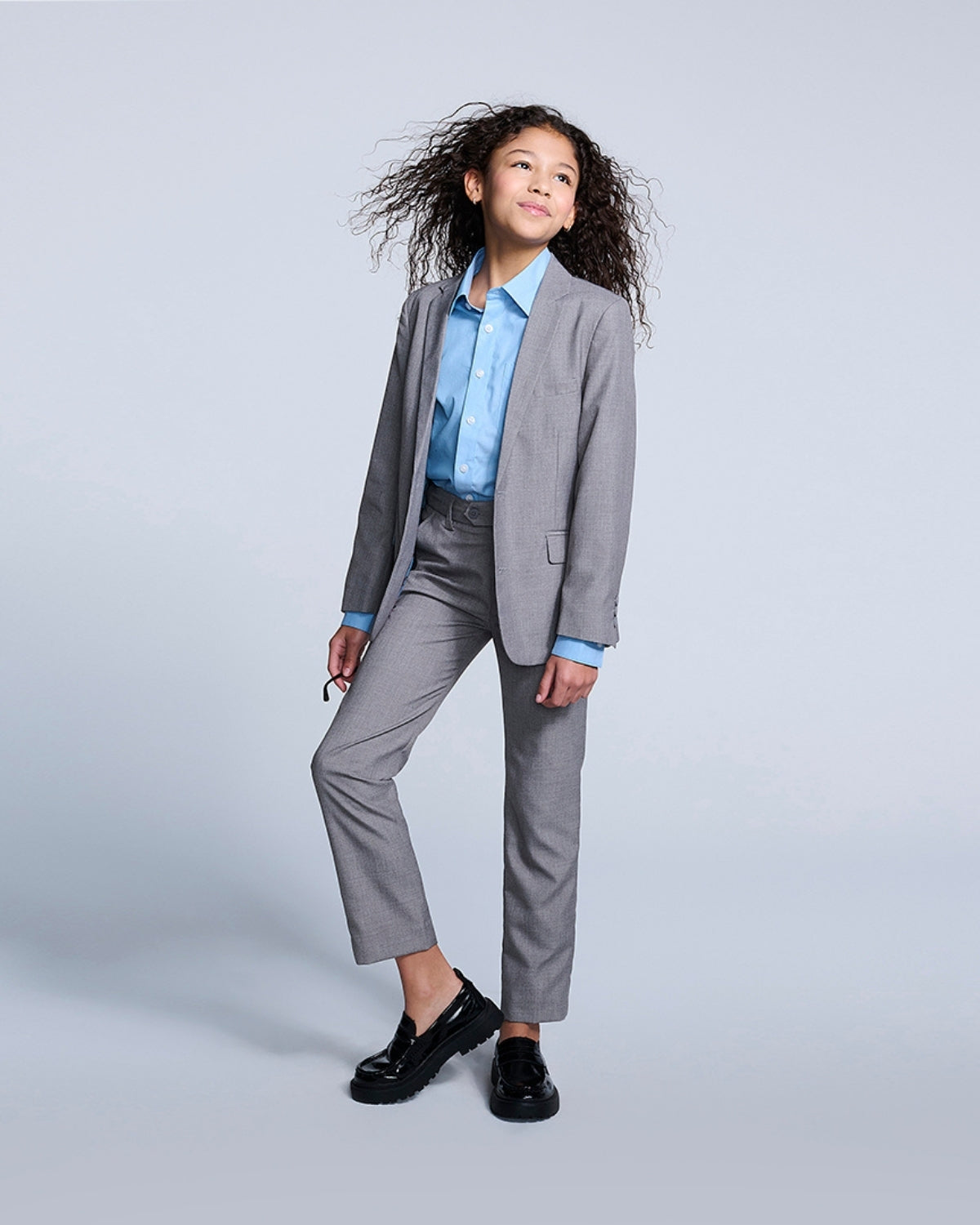 Stylish young girl in a sleek gray Mist suit with a light blue shirt, ready to rock any formal event with confidence!