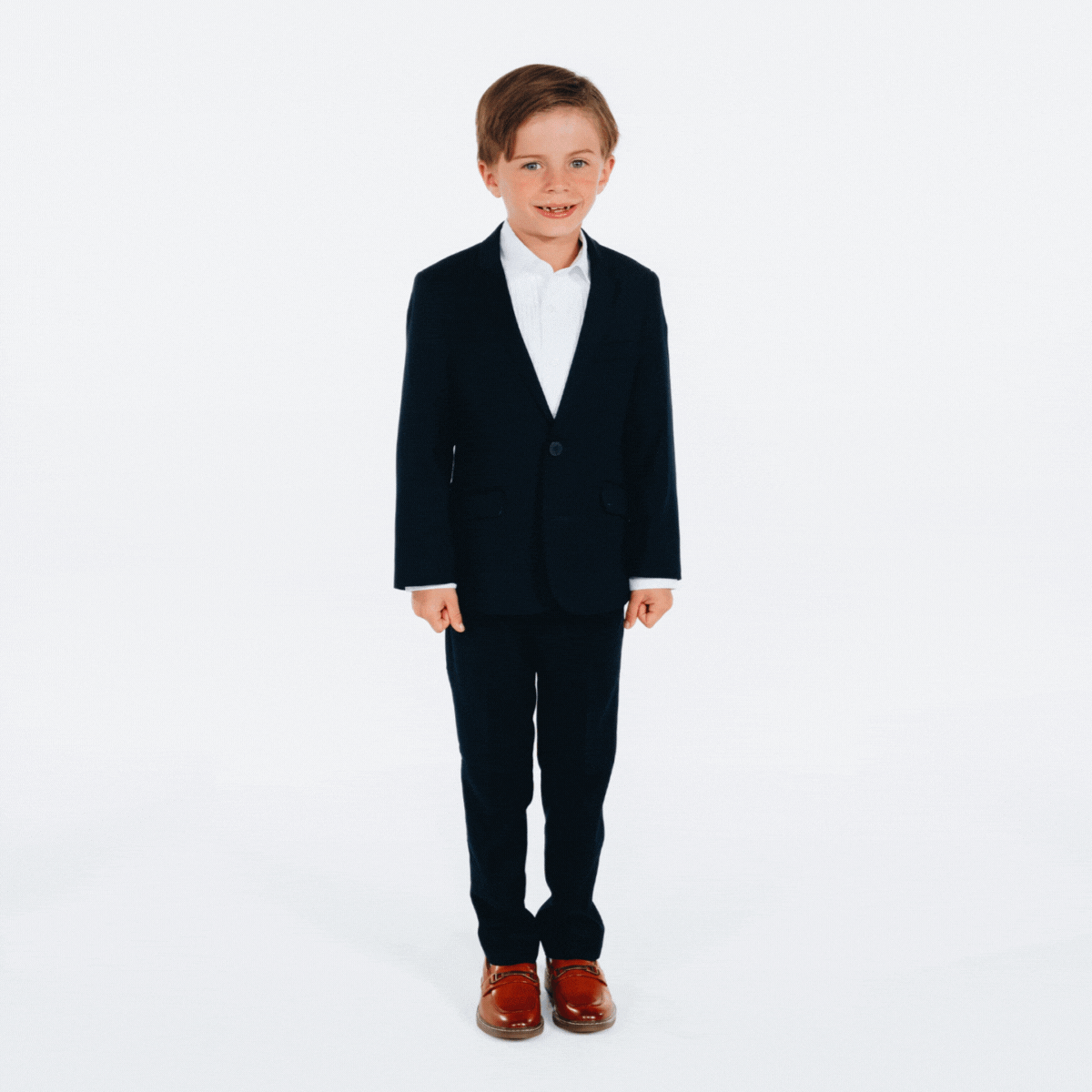Stylish boy dressed in a sleek, black Mod Suit by Appaman, showcasing modern kids' fashion with a playful twist.