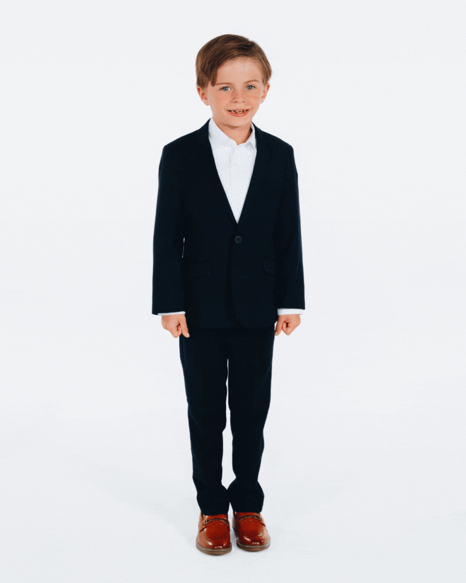 A young boy wearing a Navy Blue Mod Suit, featuring a tailored fit, classic details, and polished style.