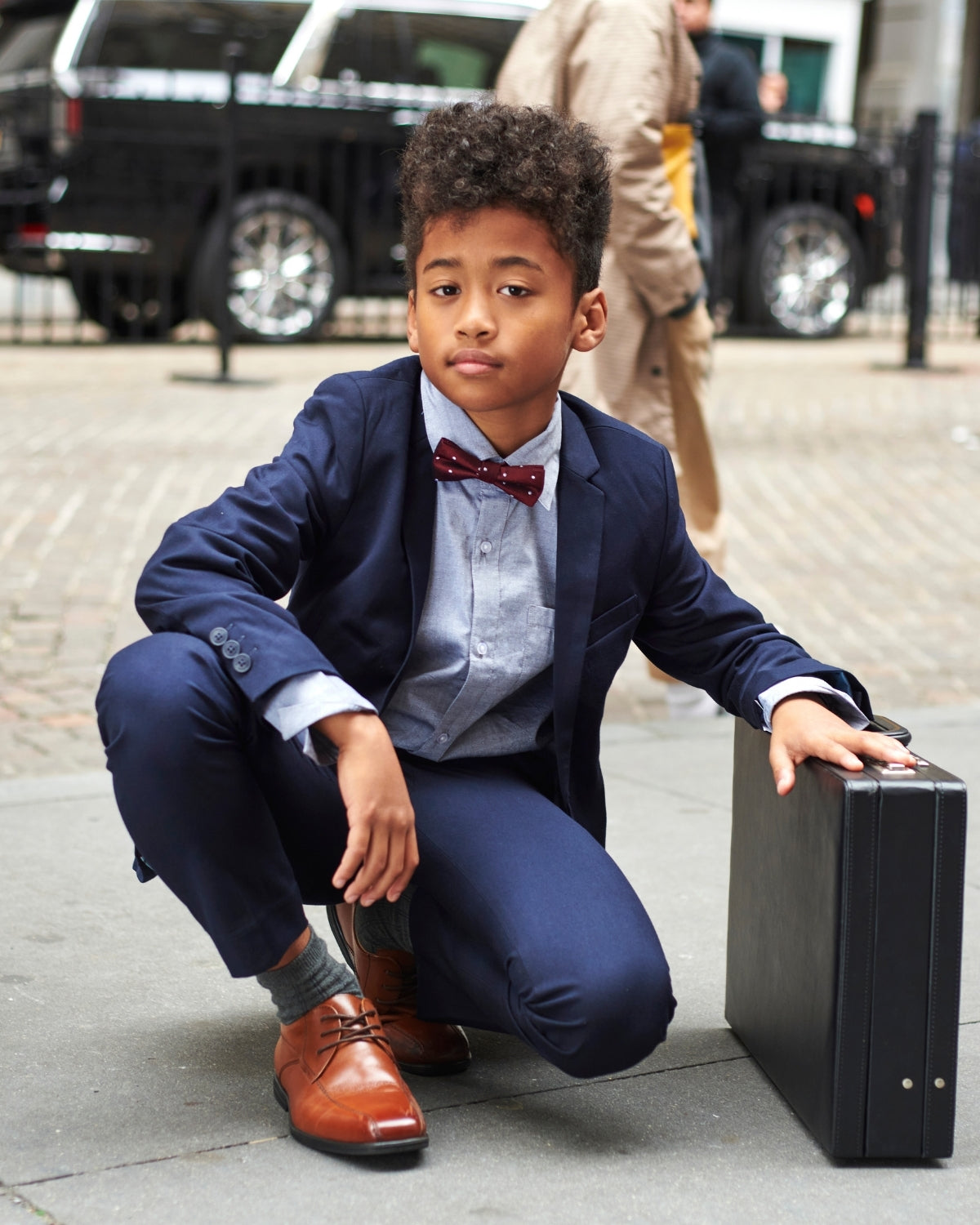 Cool kid rocking a navy blue mod suit and bow tie, ready to steal the spotlight in style.