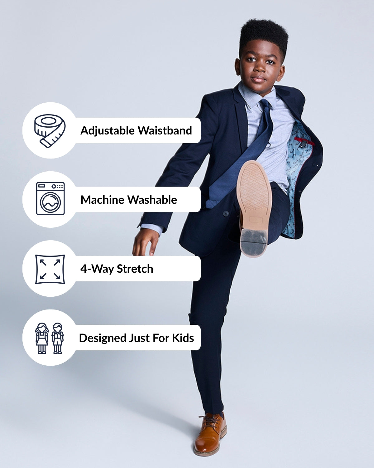 Boy wearing Navy Blue Mod Suit demonstrating adjustable waistband, machine washable fabric, and 4-way stretch features.