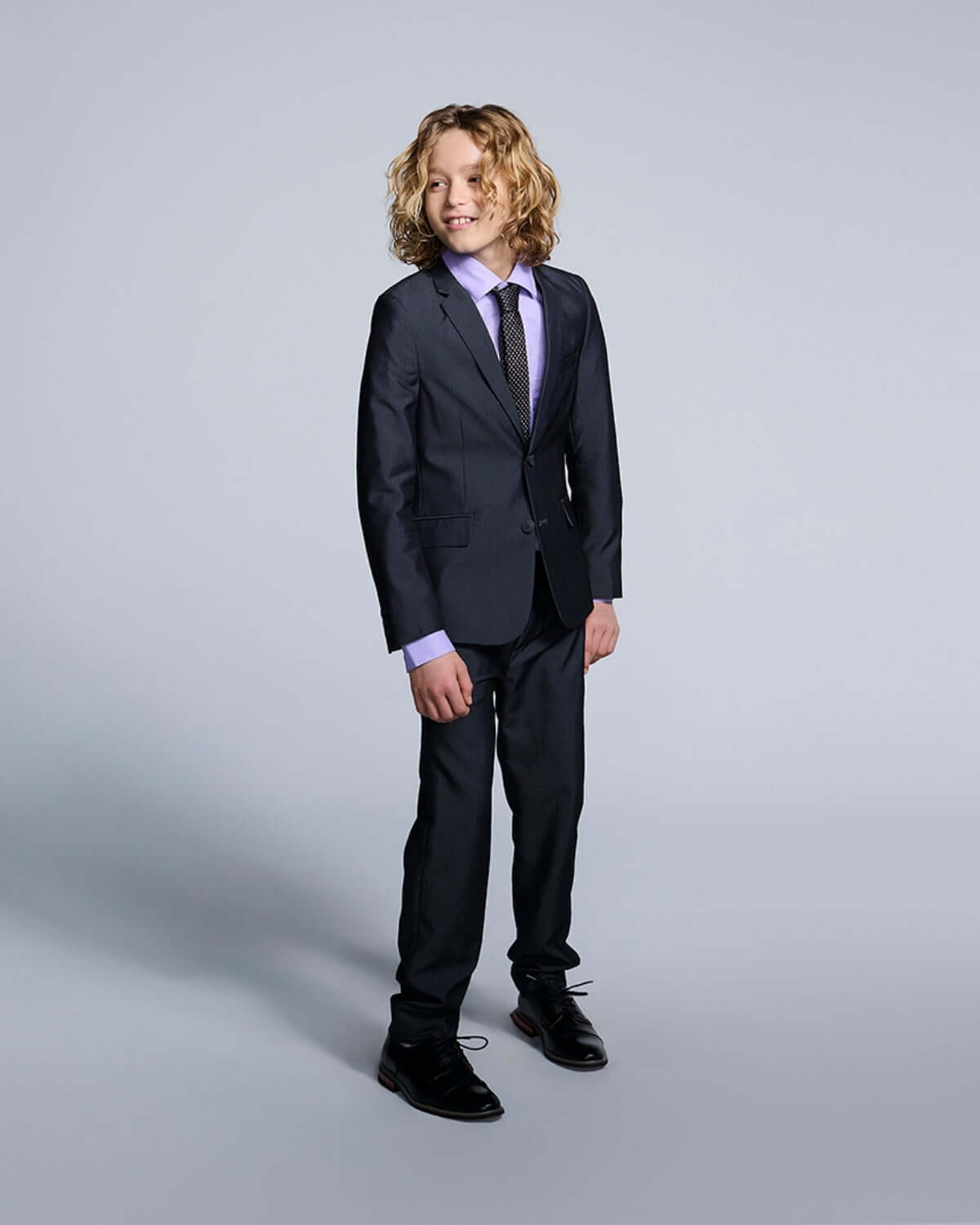 Boy wearing Lavender Purple Standard Button Down shirt with a dark suit, showcasing a polished look for young trendsetters.