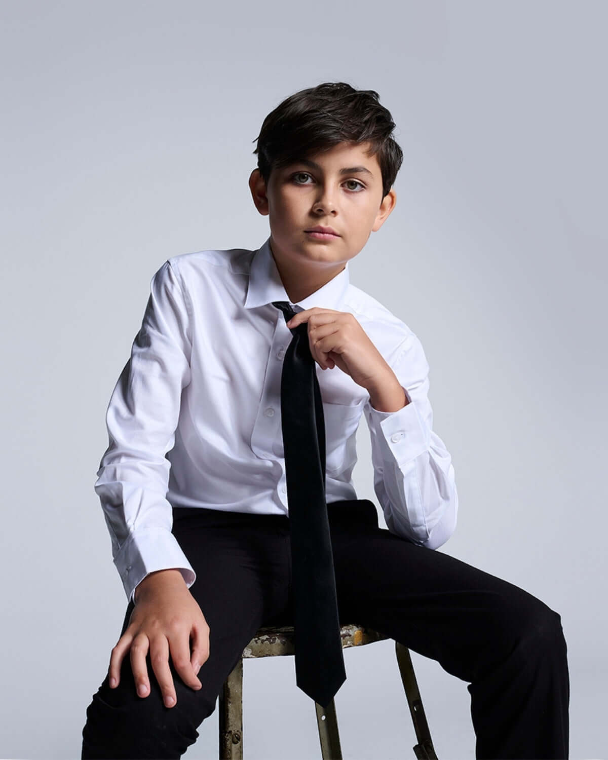 Stylish boy wearing Premium White Standard Button Down shirt with tie for formal occasion.