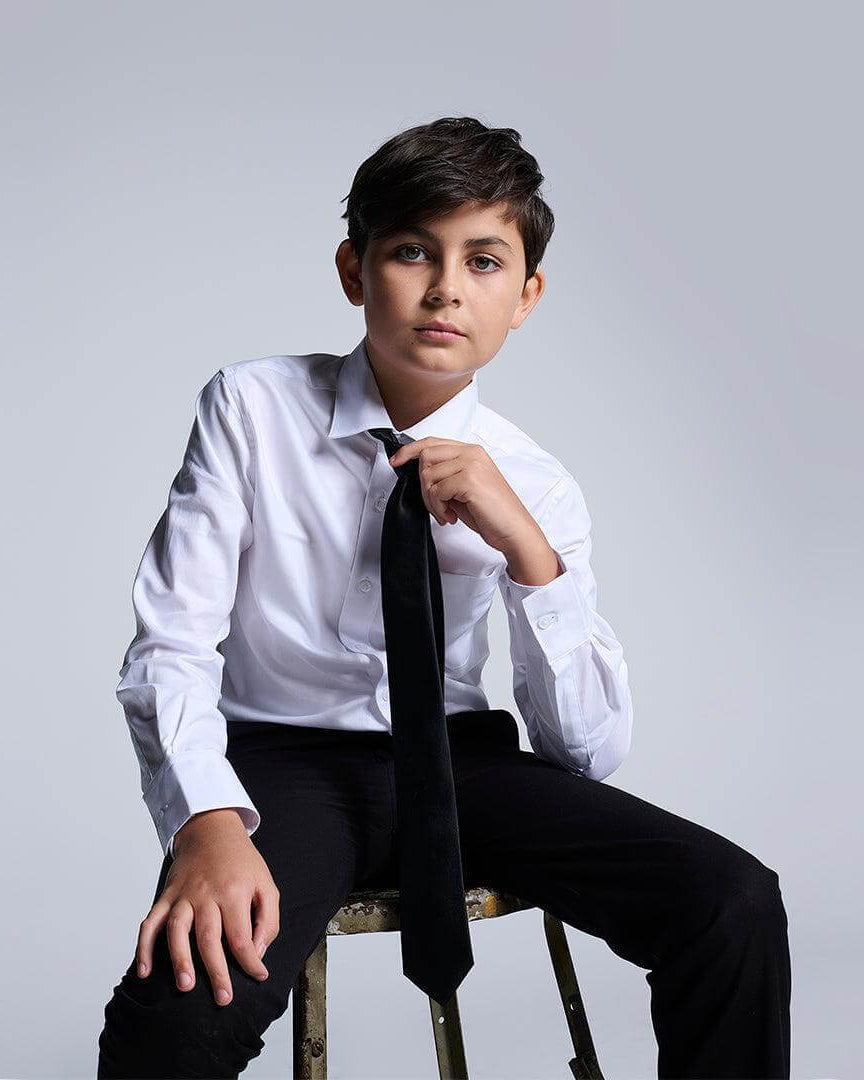 Stylish boy in a premium white dress shirt and tie, ready for formal fun in trendy kids clothes!