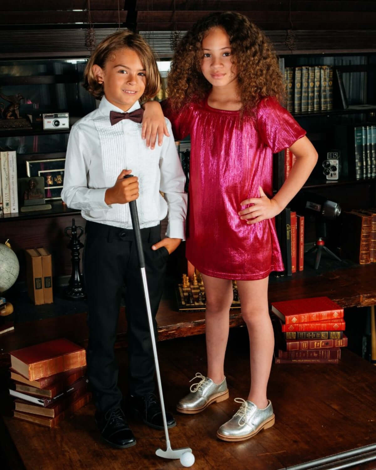 Stylish children in a classic White Tuxedo Shirt and a pink dress at a formal event setting.