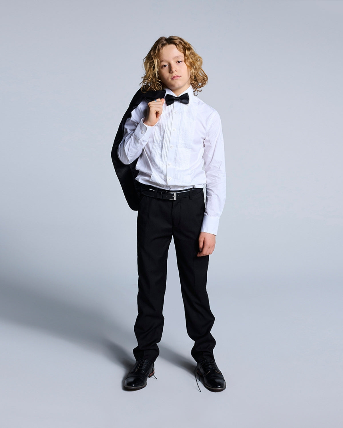 Dapper little gentleman in a classic white tuxedo shirt, ready to steal the spotlight at any formal event.