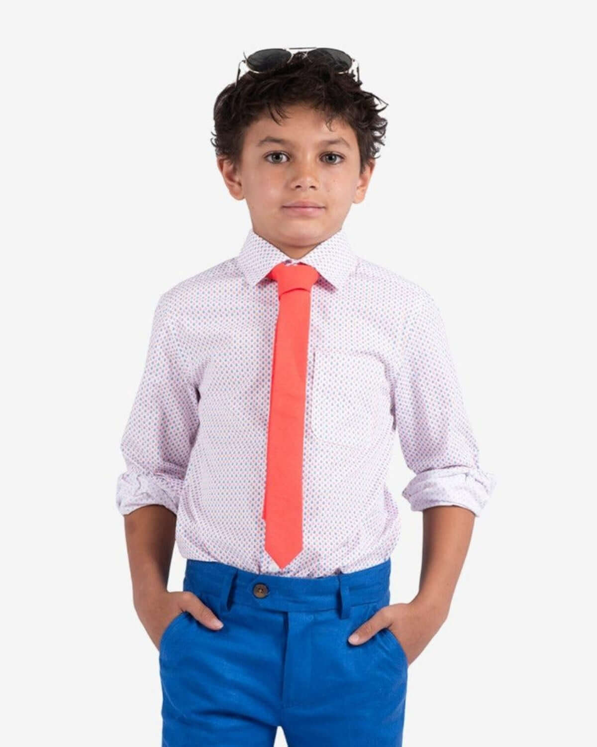Stylish boy in an anchor print shirt and vibrant red tie, ready to make waves in high-quality back-to-school kids clothes.