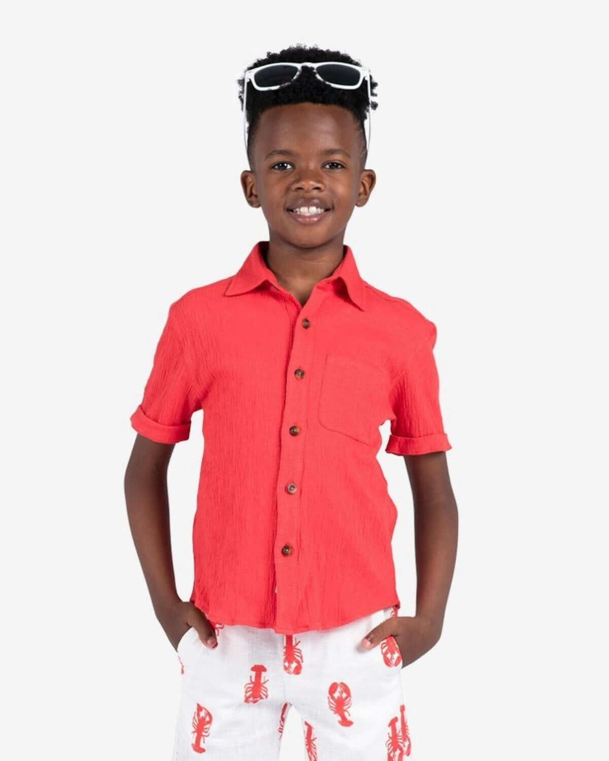 Bright and playful Coral Beach Shirt on a stylish boy, perfect for back-to-school adventures in high-quality kids clothes.