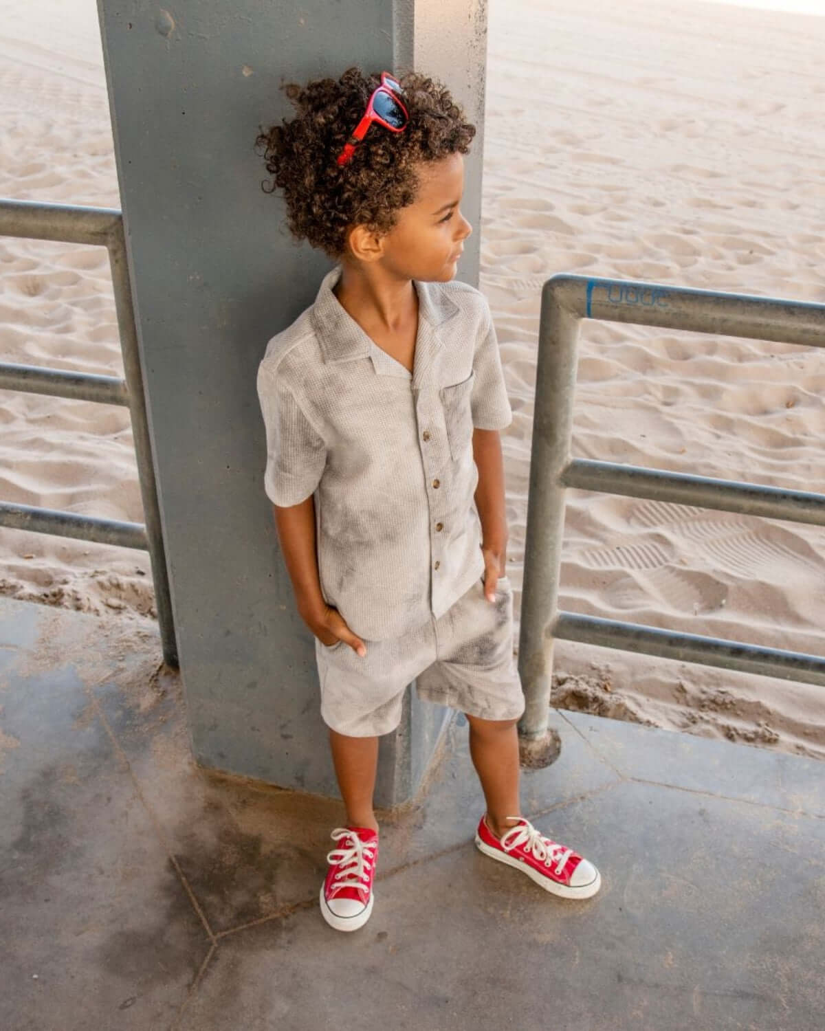 Child wearing a Grey Tie Dye Resort Shirt and matching shorts at the beach.