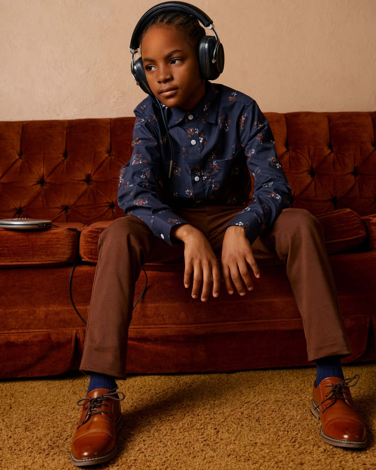 Stylish kid in a Midnight Floral button down, rockin’ headphones and cool shoes, ready for any back-to-school adventure!