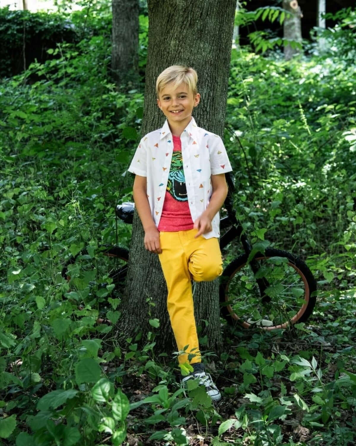 Stylish kid in a playful Paper Planes Day Party Shirt, perfect for vibrant adventures and back-to-school fun!
