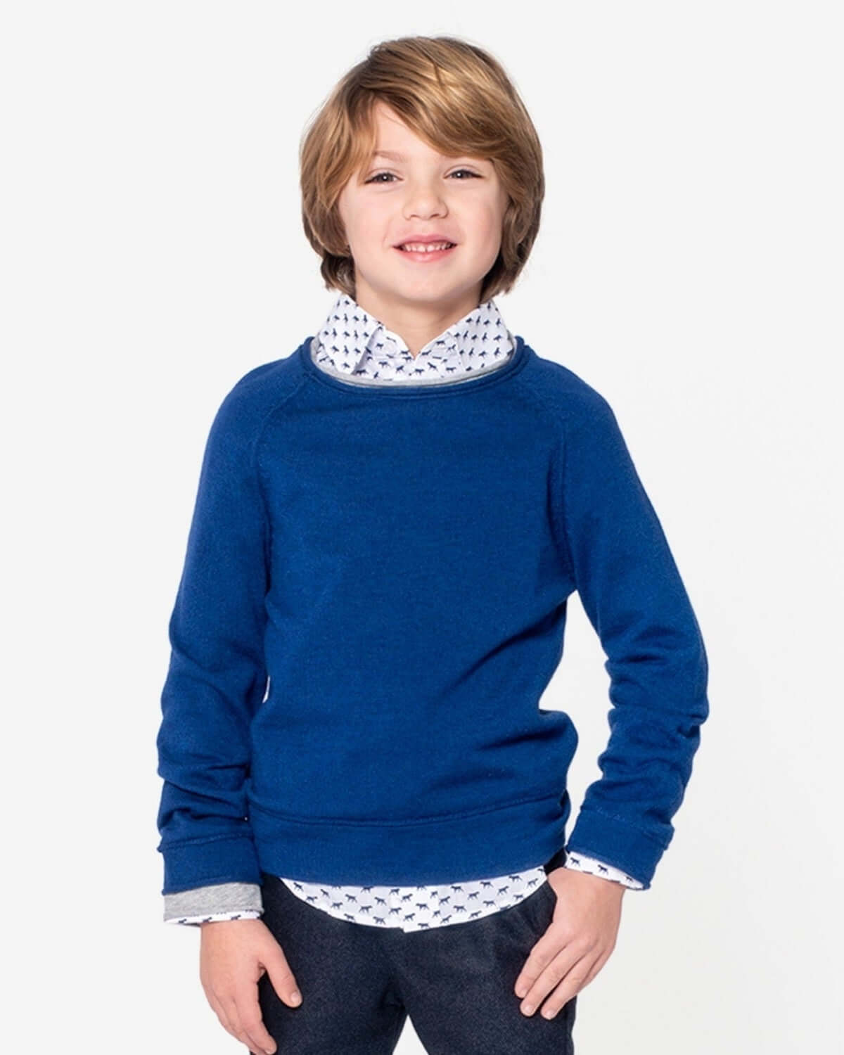 Stylish boy models the royal blue Jackson sweater, perfect for kids' back-to-school fashion—comfort meets sophistication!