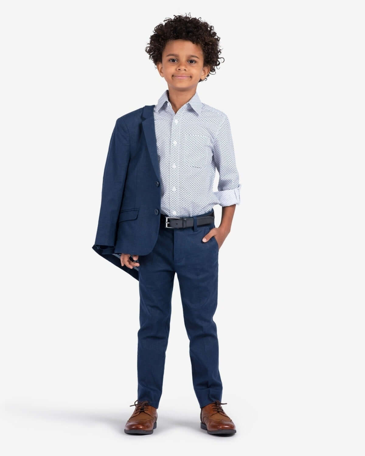 Stylish boy in a navy blazer and polka-dot shirt, ready to impress in high-quality kids clothes for back to school.