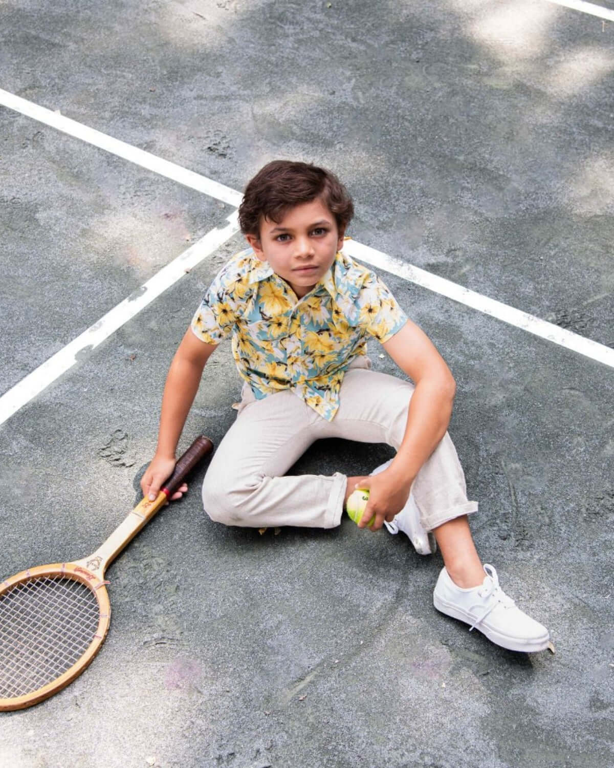 Cool kid rocking a Spring Bloom Day Party Shirt on the tennis court—stylish, fun, and ready for sunny adventures!