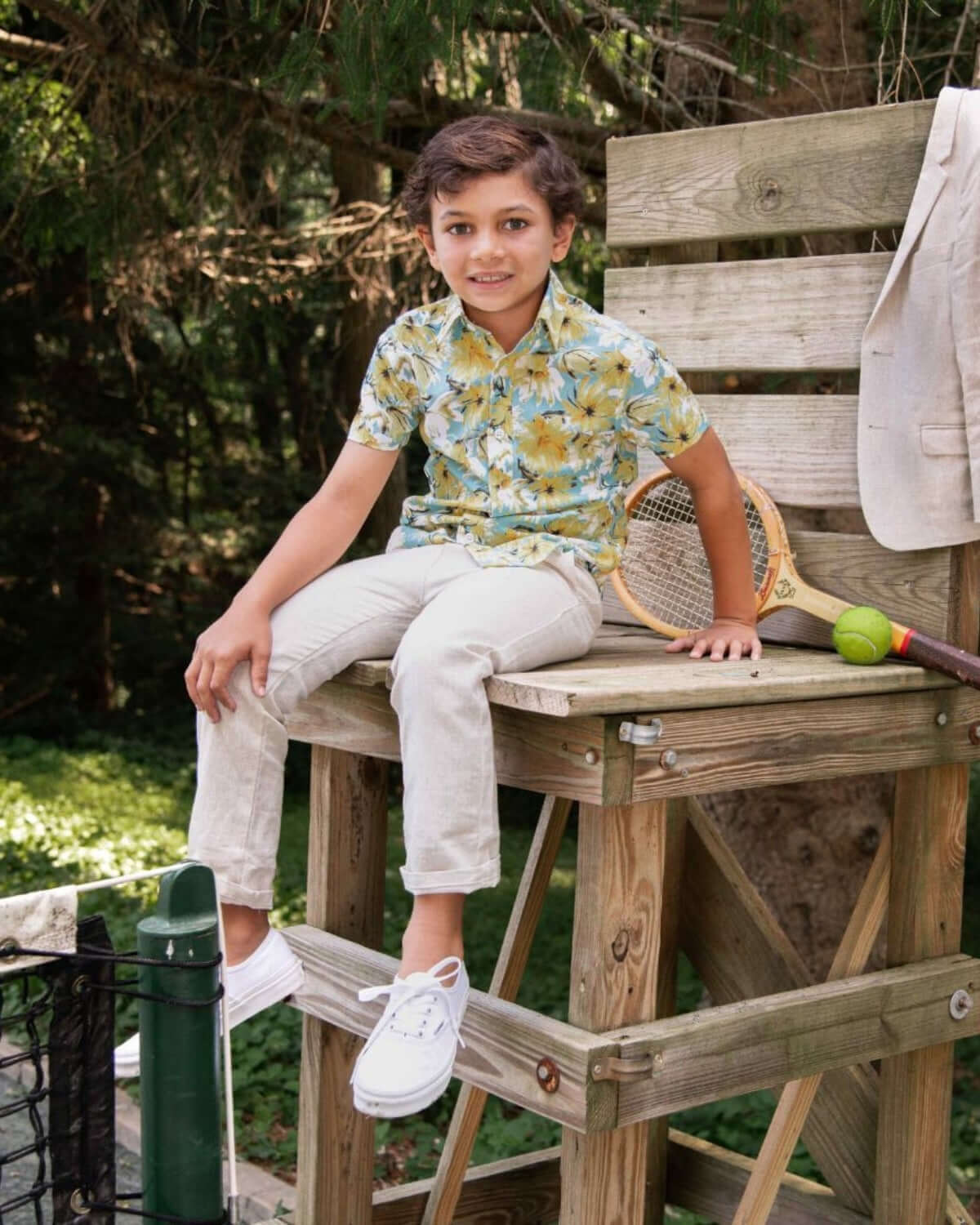 Stylish boy in a floral Spring Bloom Day Party Shirt enjoying his time on a playful summer afternoon.