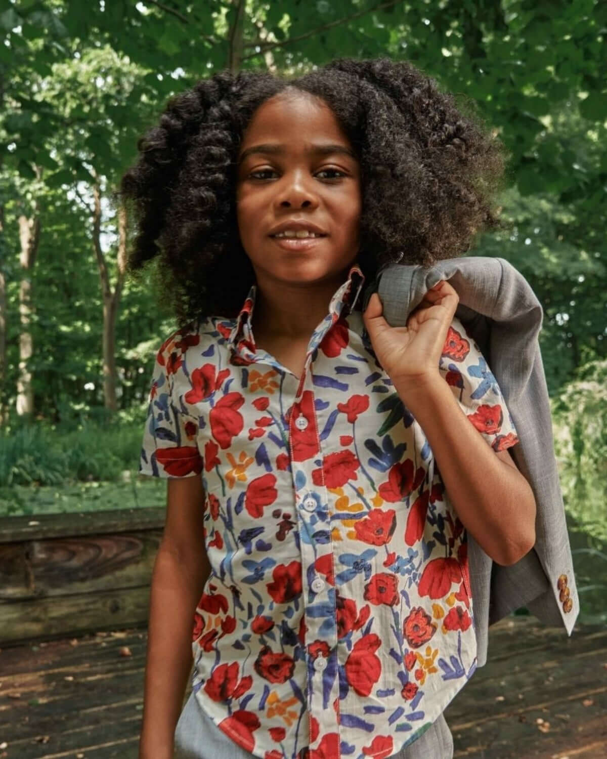 Stylish kid in a floral shirt, ready to shine at a party—high-quality kids clothes for every fun moment!