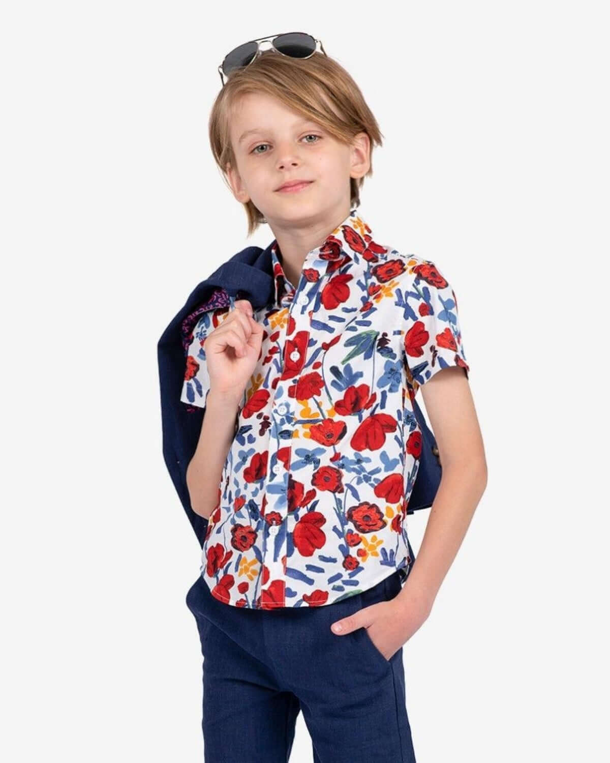 Stylish boy in a vibrant floral shirt, ready for adventure in kids clothes that blend fun and quality.