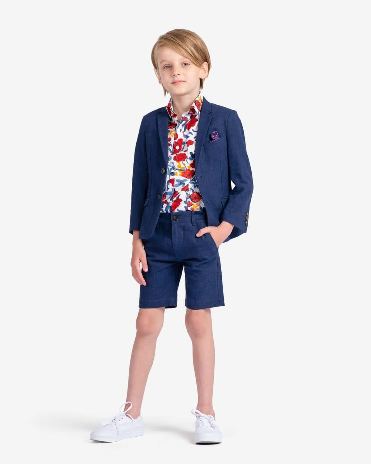 Stylish boy's outfit featuring a vibrant floral shirt and chic shorts—perfect kids clothes for fun day parties!