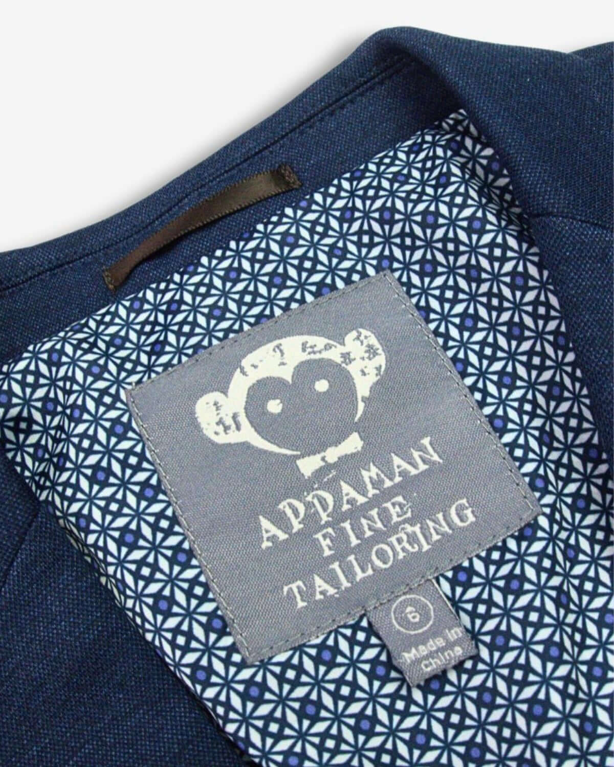 Appaman's playful logo inside a stylish boys suit, showcasing high-quality kids clothes with a modern flair.