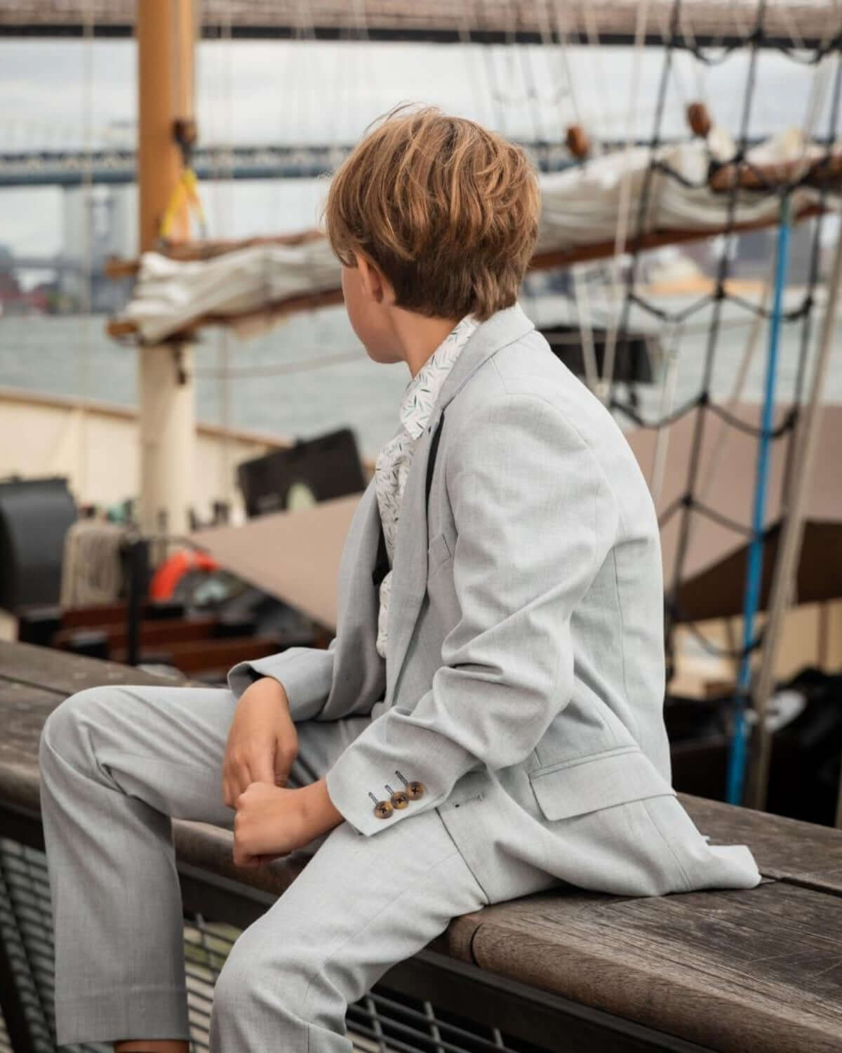 Stylish kid in a High Rise Grey Stretchy Mod Suit, ready for adventures on the water with a chic and modern vibe.