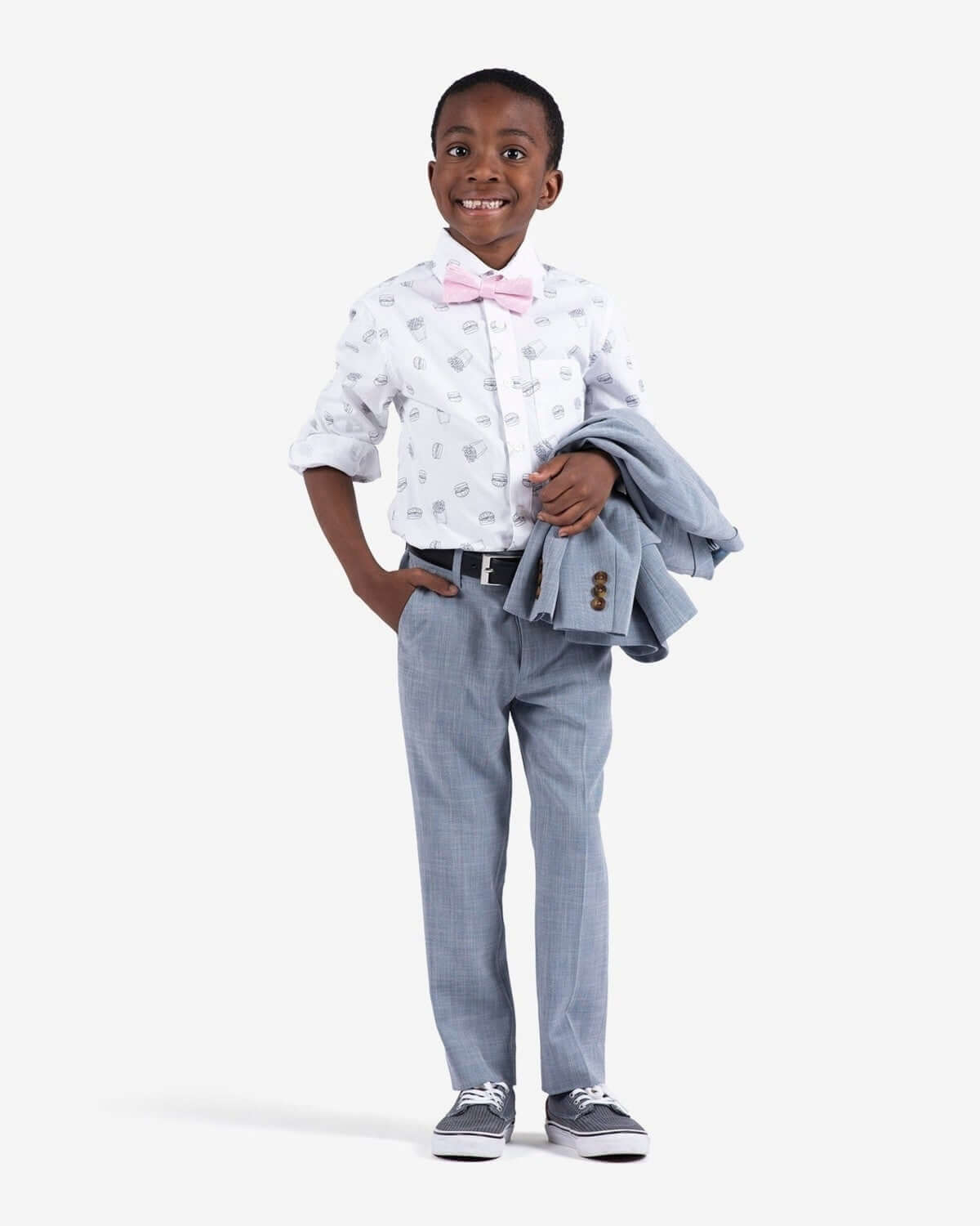 Stylish boy in a modern suit with pink bow tie, ready for back to school fun in high-quality kids clothes.
