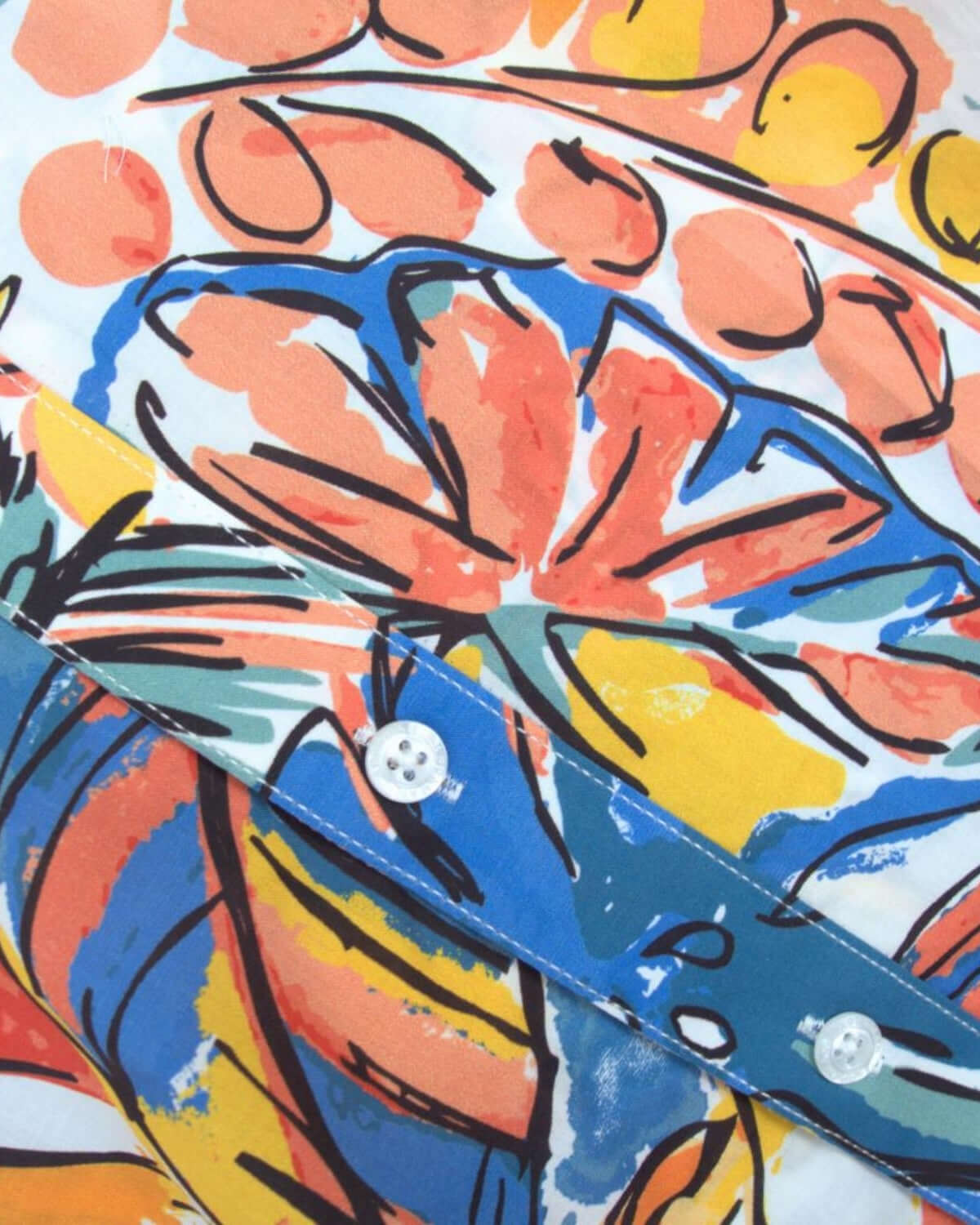 Close-up of vibrant Artist Flora print on a boys' short sleeve dress shirt—stylish kids clothes for playdates and family outings!
