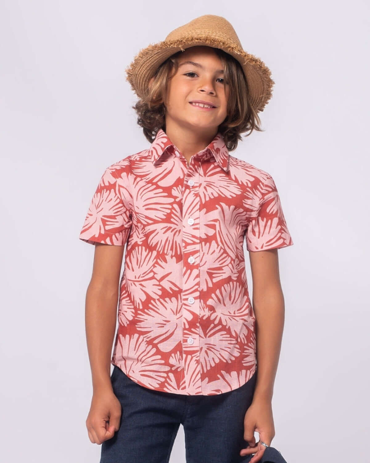 Happy kid in a clay garden shirt, perfect for sunny days and stylish outdoor adventures in high-quality kids clothes.