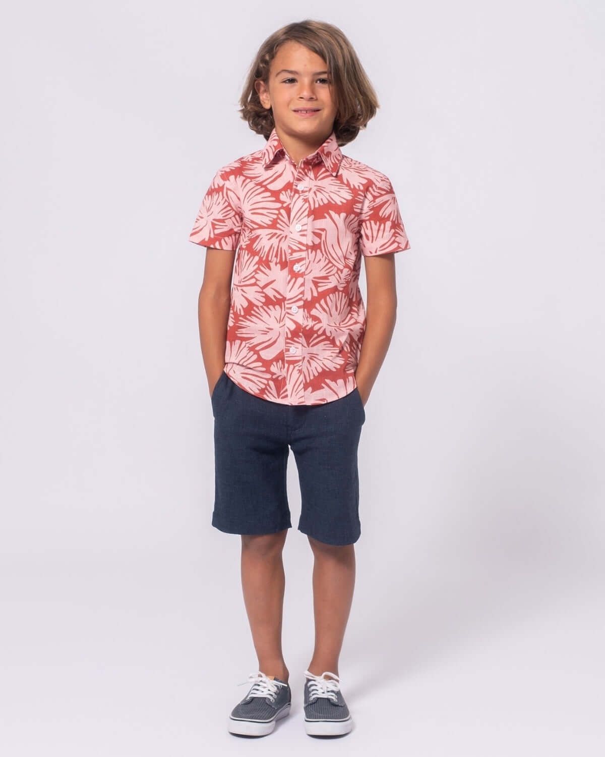 Stylish kid wearing a clay garden button-up shirt, perfect for fun outdoor adventures and back-to-school style.