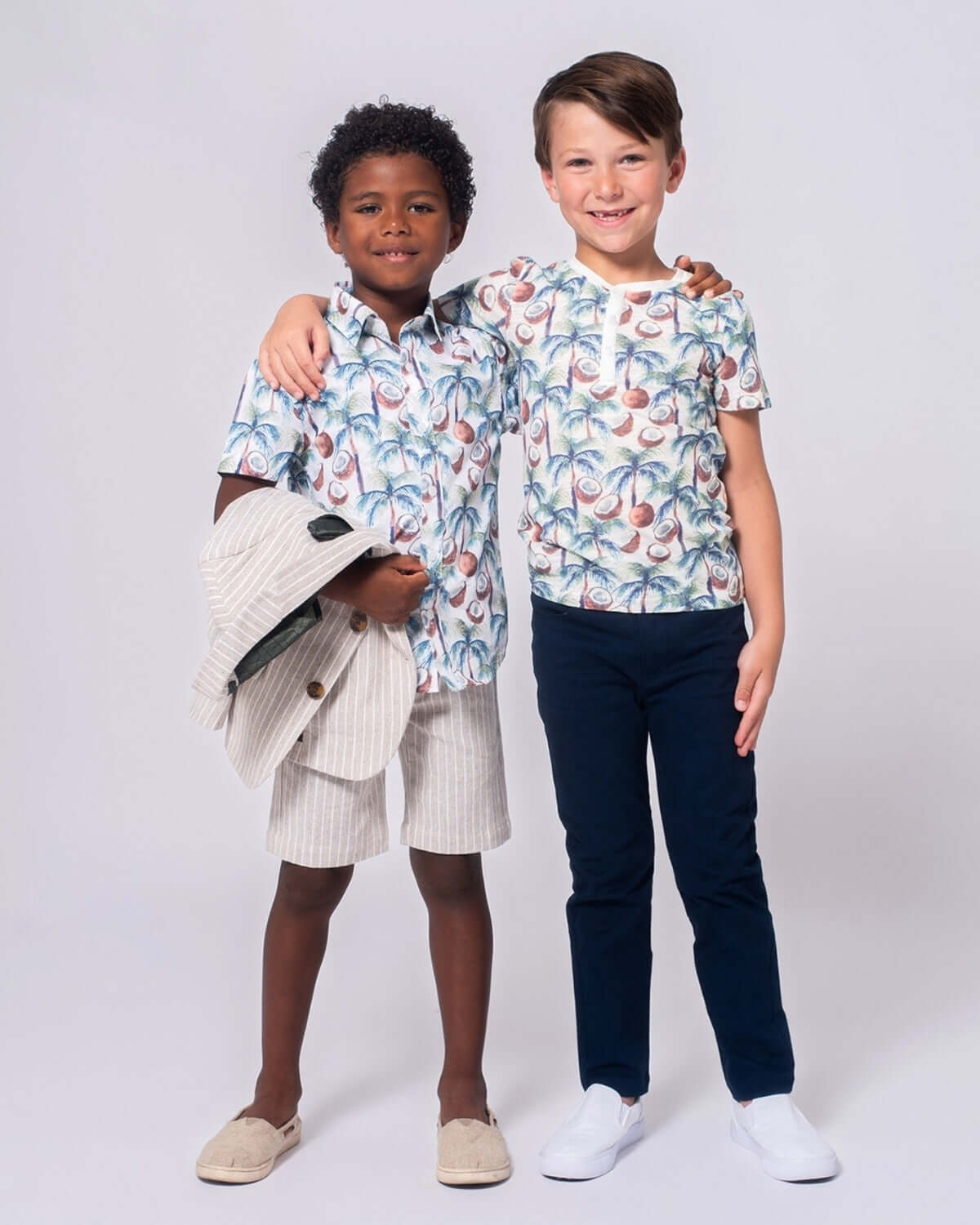 Two stylish boys in colorful tropical shirts, showcasing fun and playful kids clothes for back to school adventures.