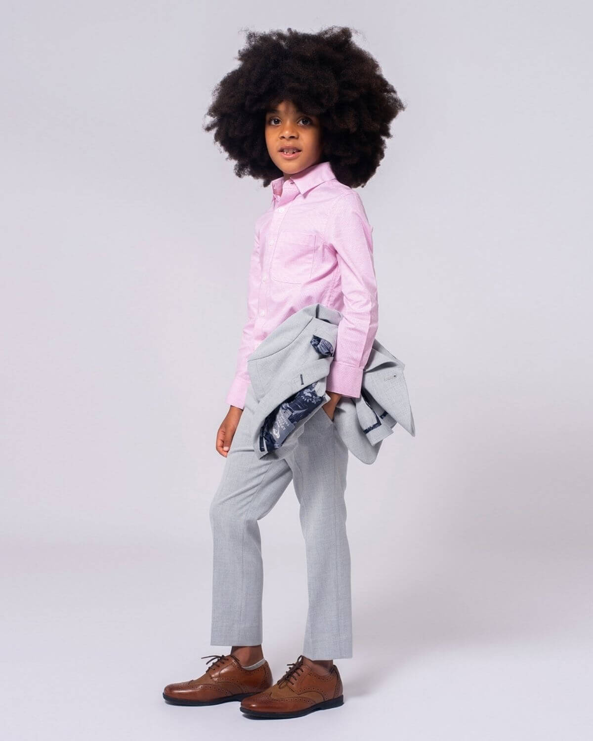 Cool kid styled in a Laveno Pink shirt, gray pants, and a chic blazer—ready to shine at school or family events!
