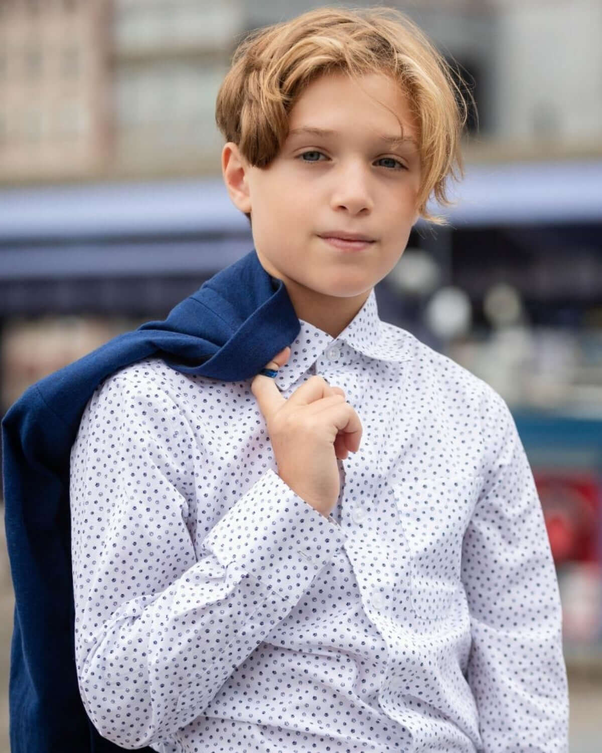 Stylish boy in a playful button-down shirt with navy blazer, perfect for back to school adventures and family fun.