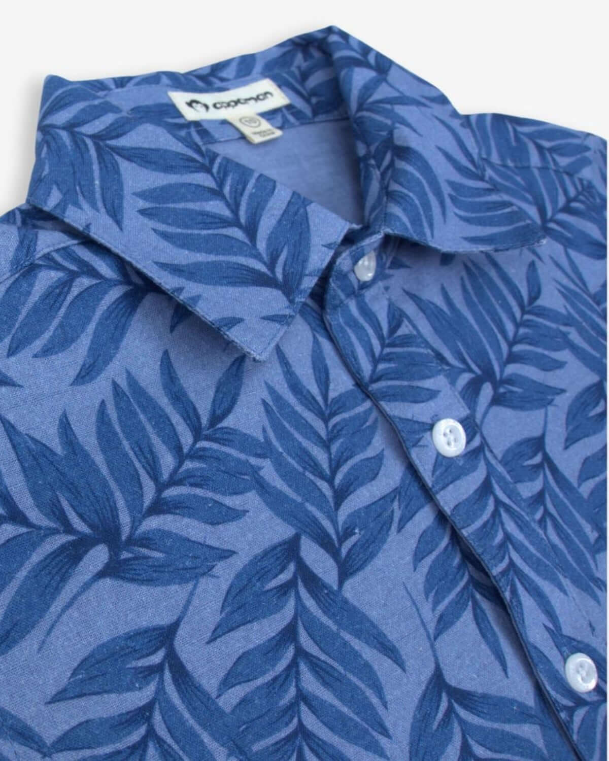 Boys Summer Blues shirt with lively leaf pattern, keeping kids stylish and cool for backyard parties and summer outings.