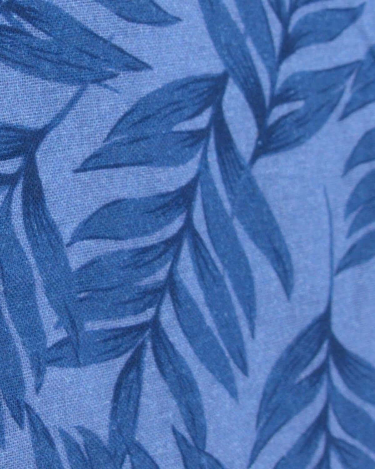 Close-up of airy blue fabric with playful leaf patterns, perfect for stylish summer outfits for kids.