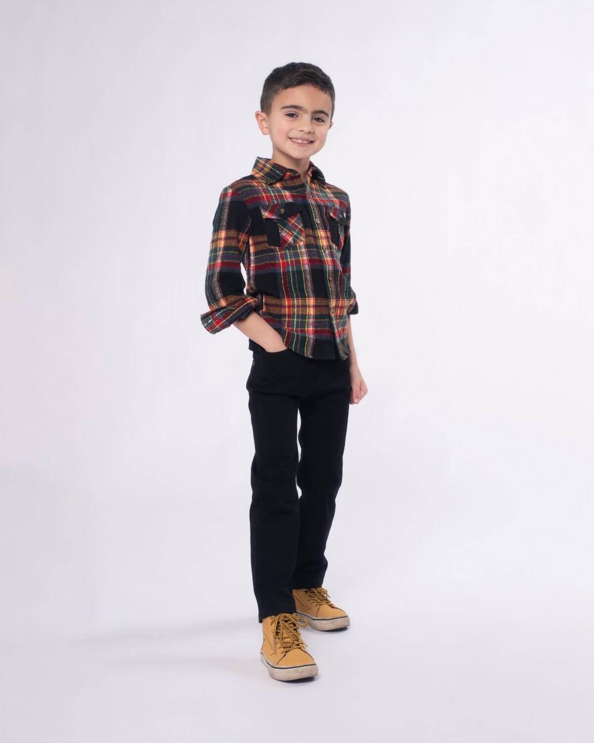 Stylish kid in a vintage tartan flannel shirt, perfect for back-to-school adventures in high-quality kids clothes!