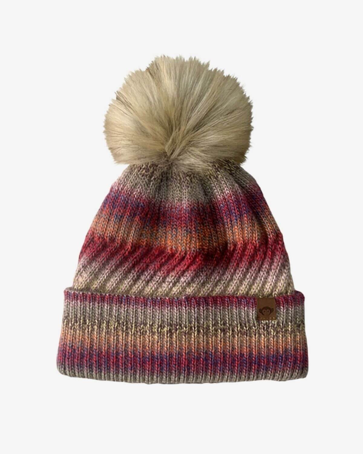 Rose Iris Pom Beanie with playful pom, cozy stripes in pink, red, and beige—a stylish must-have for kids' winter wear.