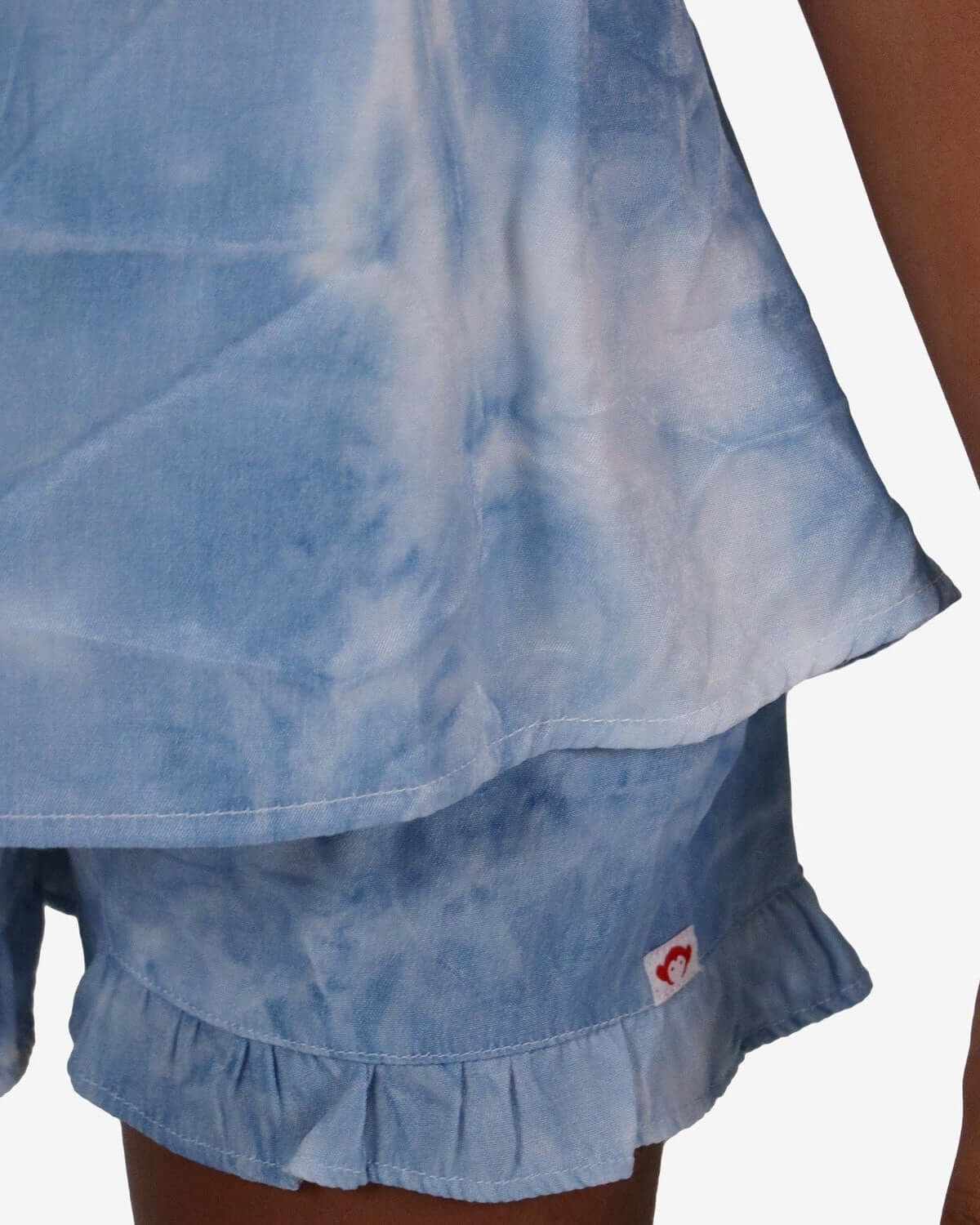 Adorable blue tie-dye Natalie shorts with flirty ruffle hem, perfect summer style for kids' playful adventures.