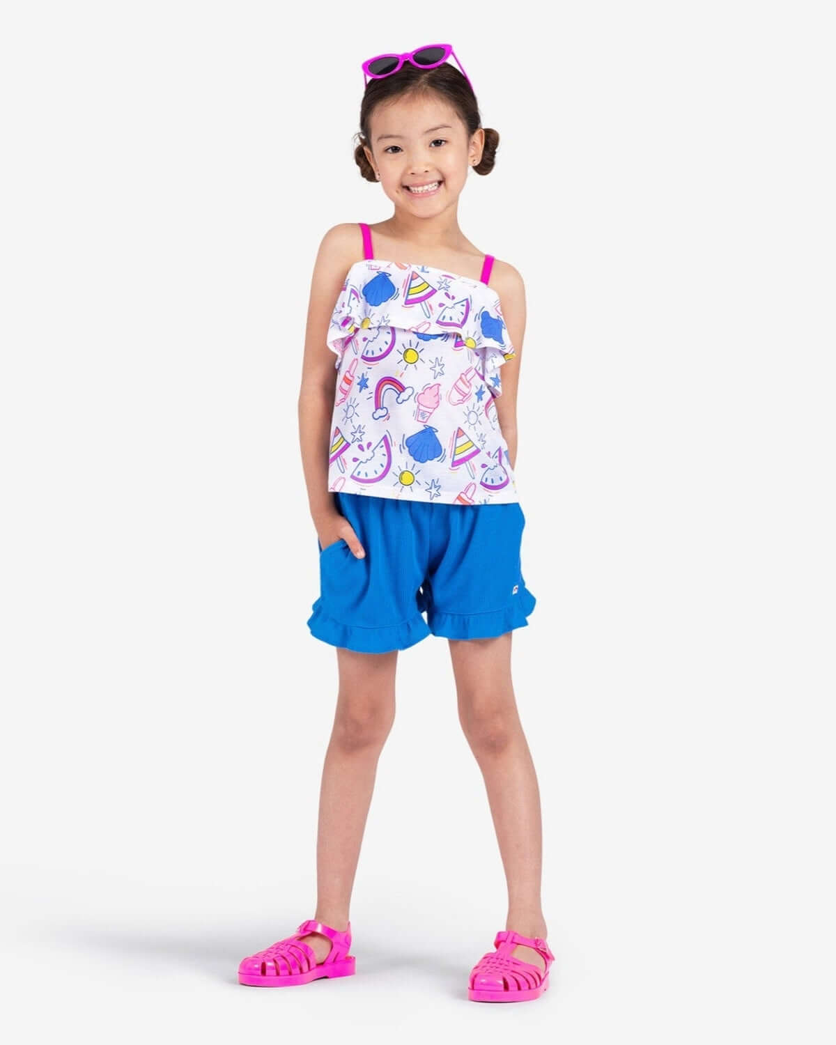 Stylish girl sporting vibrant Cobalt Blue Natalie Shorts, ready for summer fun with cozy pockets and a playful top.