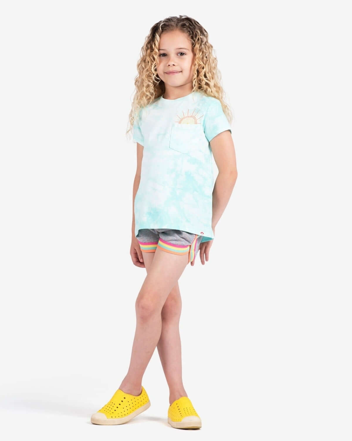 Stylish kid in playful tie-dye tee and sparkle Lori shorts, ready for back-to-school fun in high-quality kids clothes!