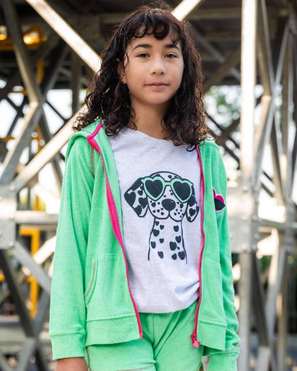 Girl wearing Mint Majorca Shorts with a stylish dog print t-shirt and a mint green hoodie.