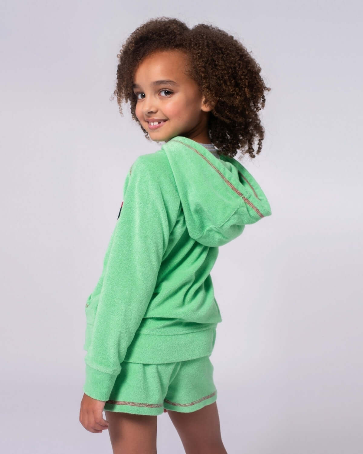 Mint Majorca Shorts paired with a matching hoodie, featuring a playful and vibrant look for summer.