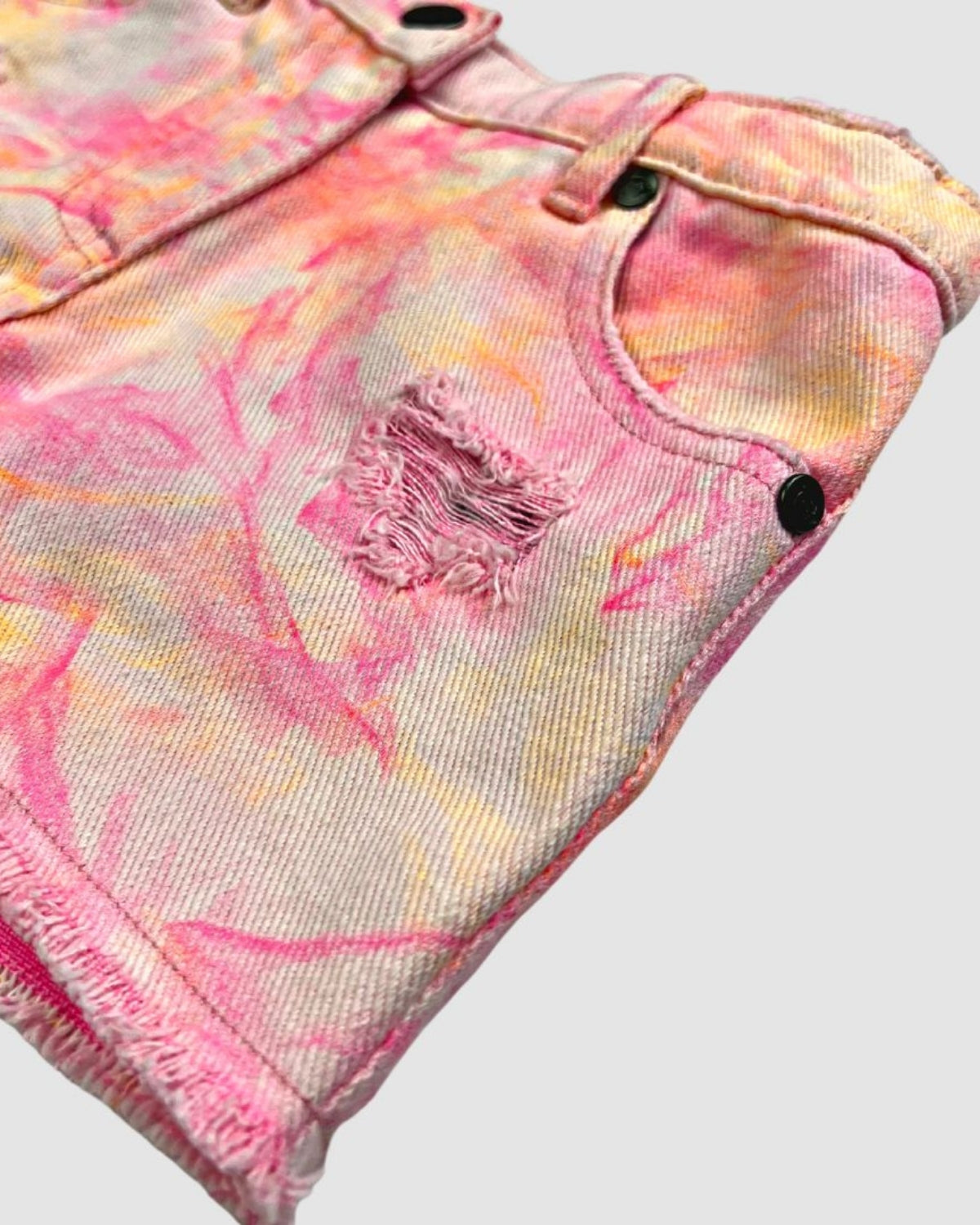 Colorful neon shorts for kids, showcasing playful pink hues and stylish distressed details—perfect for summer adventures!