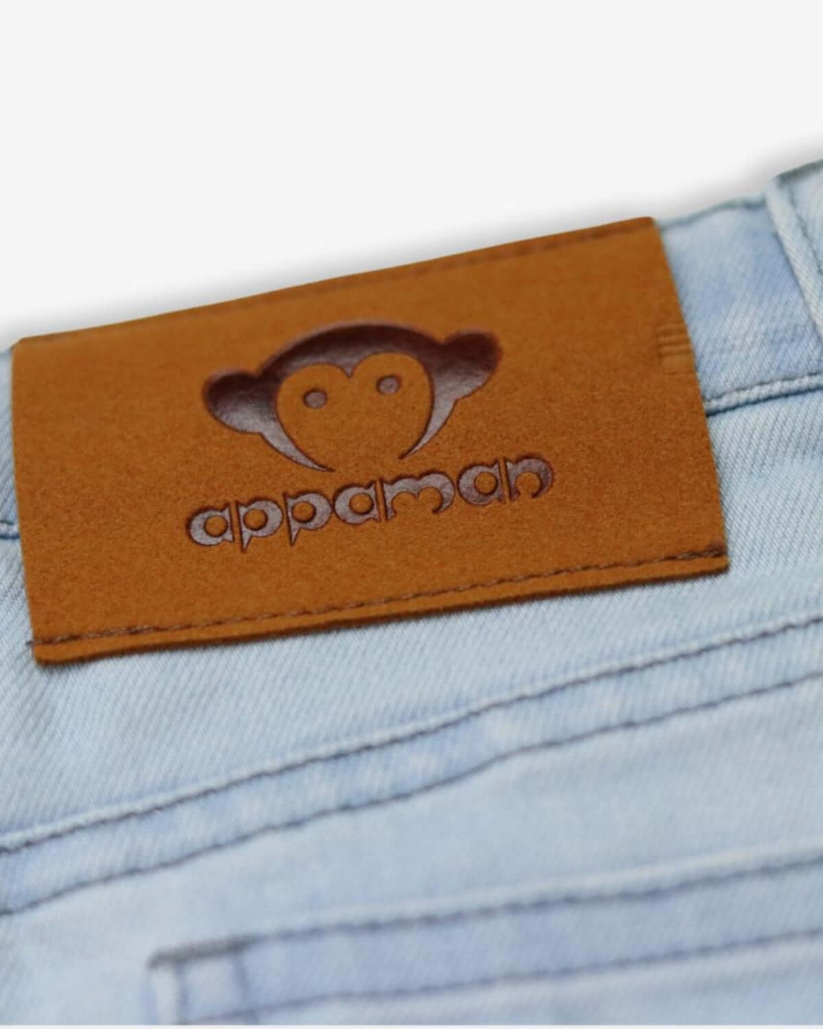 Close-up of the Appaman logo patch on denim shorts, showcasing quality and playful style for kids' fashion.
