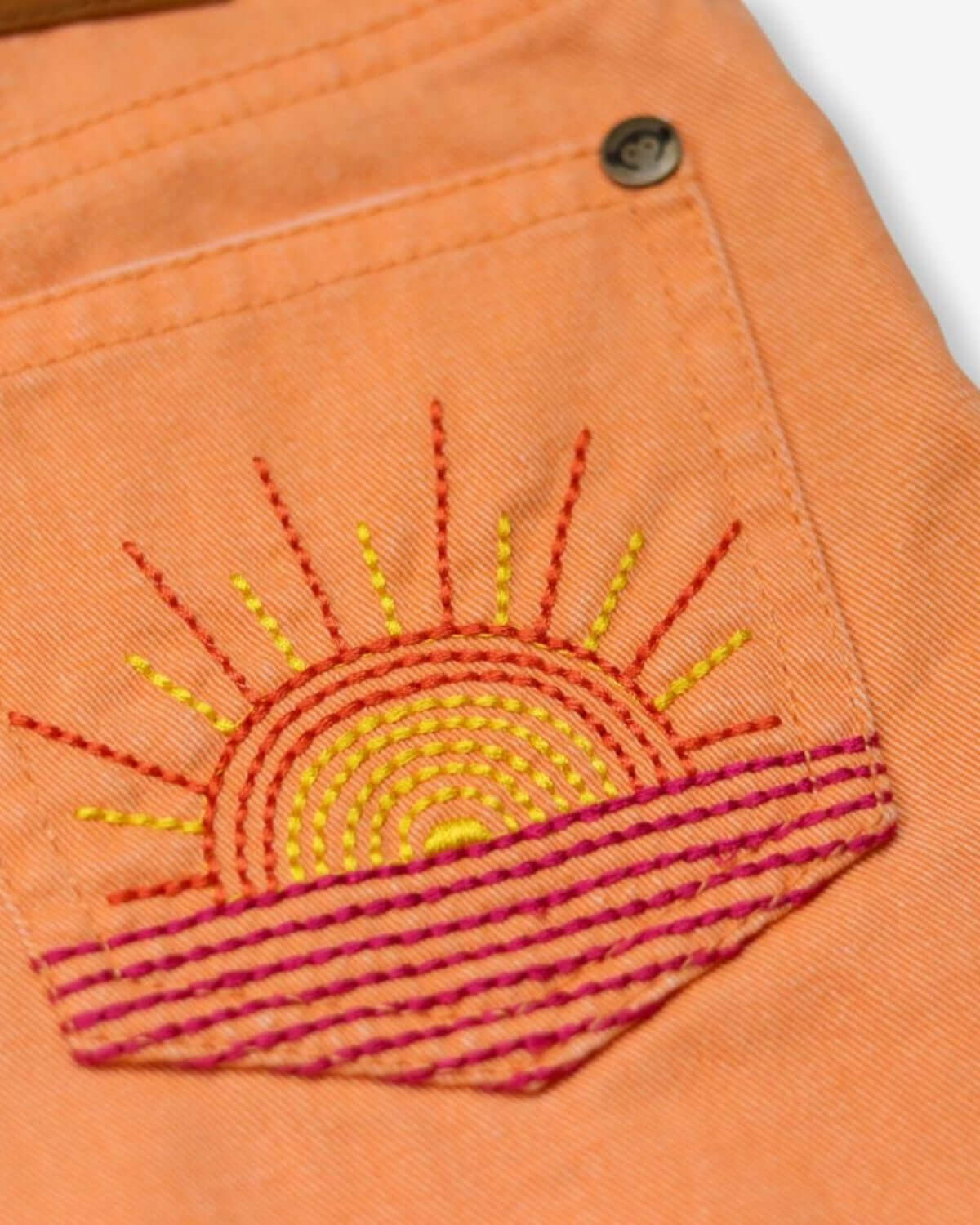 Vibrant sunset embroidery on Sunburst Orange Rhodes Shorts, perfect for summer adventures in kids clothes.