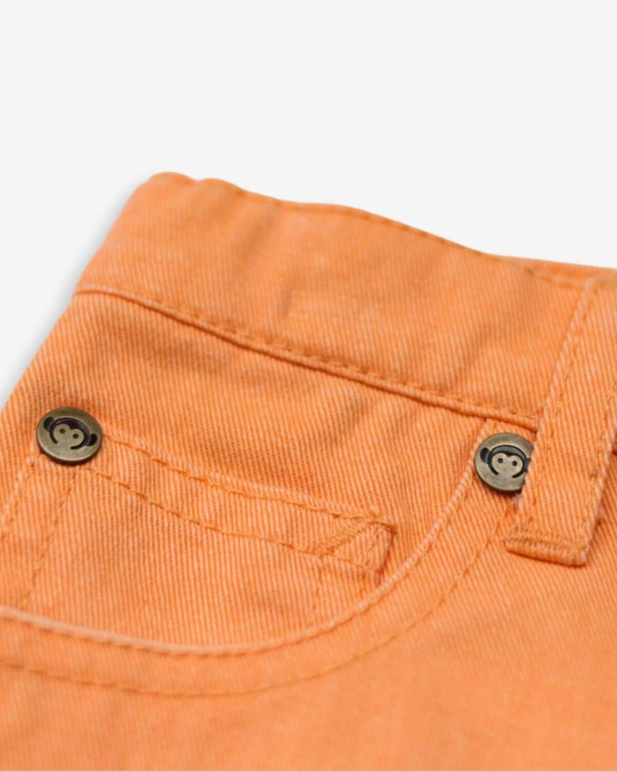 Close-up of vibrant Sunburst Orange Rhodes Shorts showcasing durable denim and playful button details for trendy kids clothes.