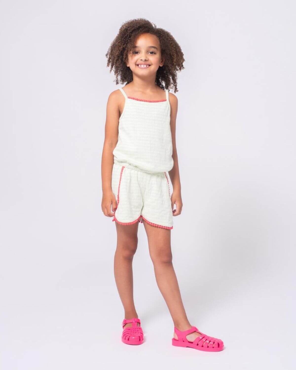 Light Green Stripe Novia Romper worn by a girl with curly hair, featuring soft fabric and stylish design.