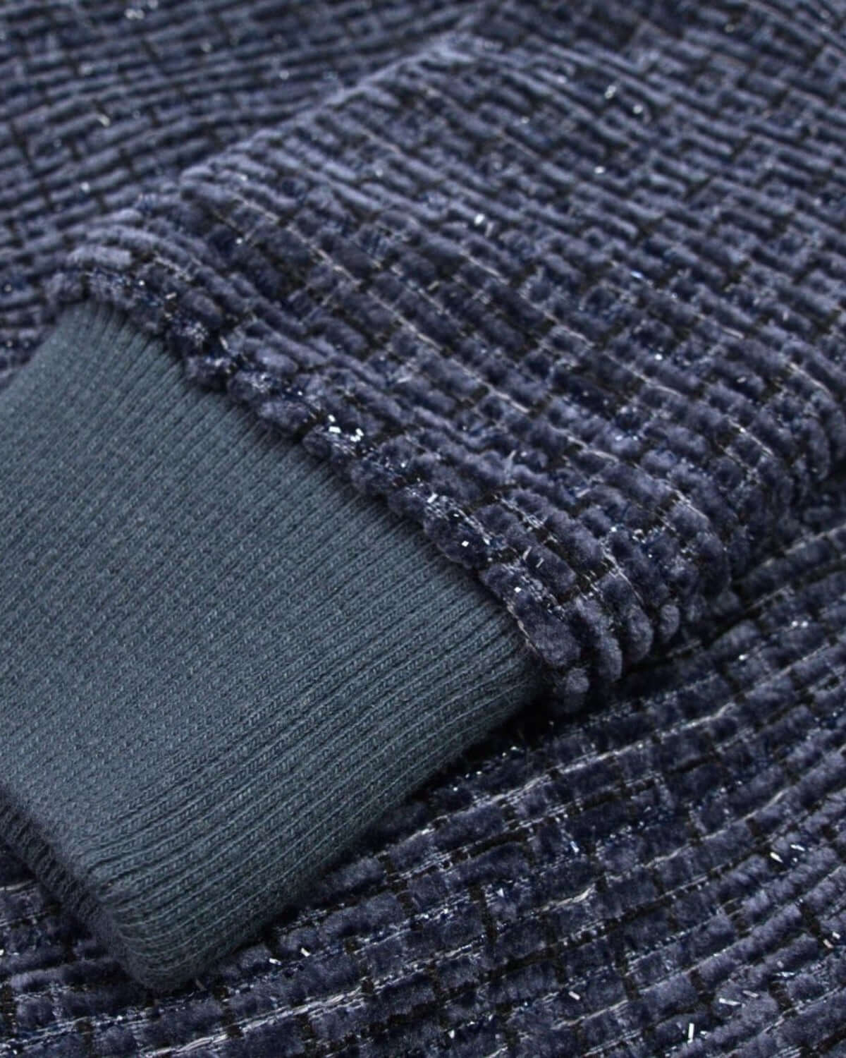 Close-up of the cozy navy velvet Willow Top's soft, textured sleeve, perfect for stylish kids during winter celebrations.