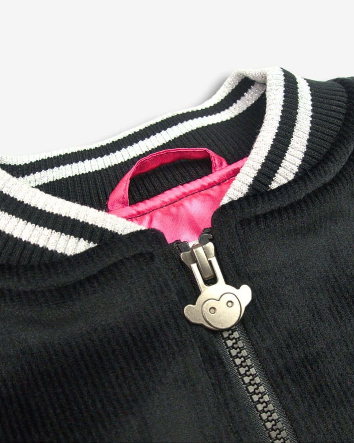 Chic black bomber jacket neckline with sparkly varsity ribbing and playful hot pink satin lining for stylish kids.